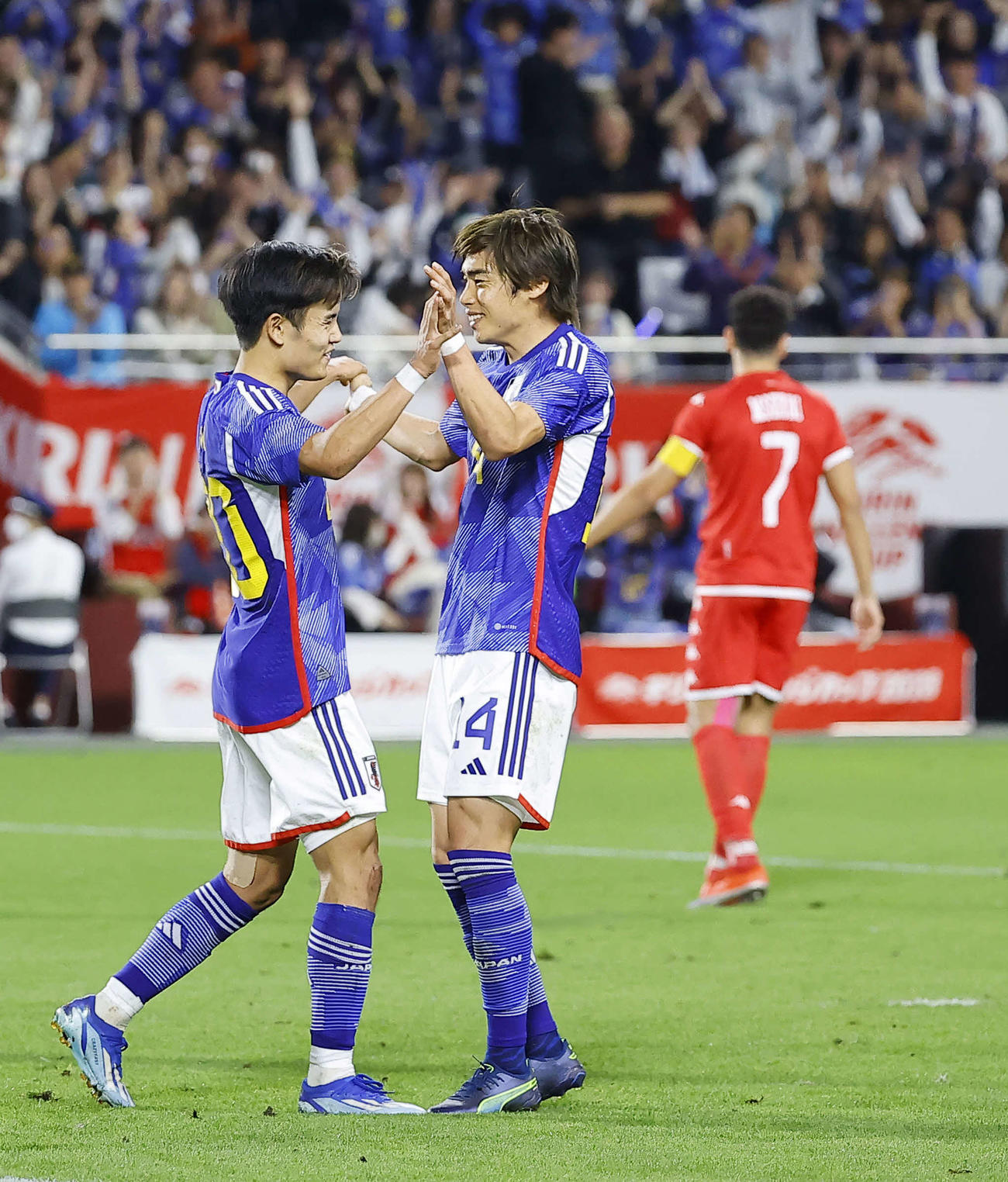 日本対チュニジア　後半、ゴールを決めた伊東（右）はアシストの久保とタッチを交わす（撮影・藤尾明華）
