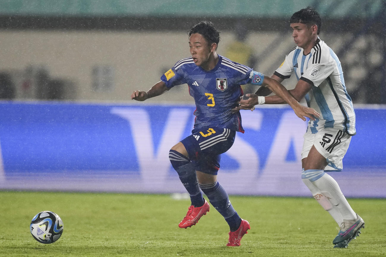 日本DF小杉啓太がアルゼンチンMFヘレスと競り合う（AP）