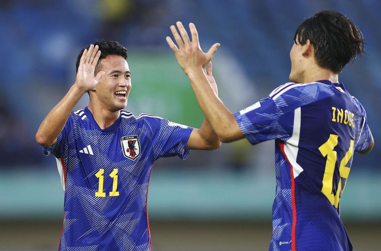 セネガル戦の後半、自身2点目のゴールを決め、タッチを交わす高岡（左）（FIFA提供・ゲッティ＝共同）