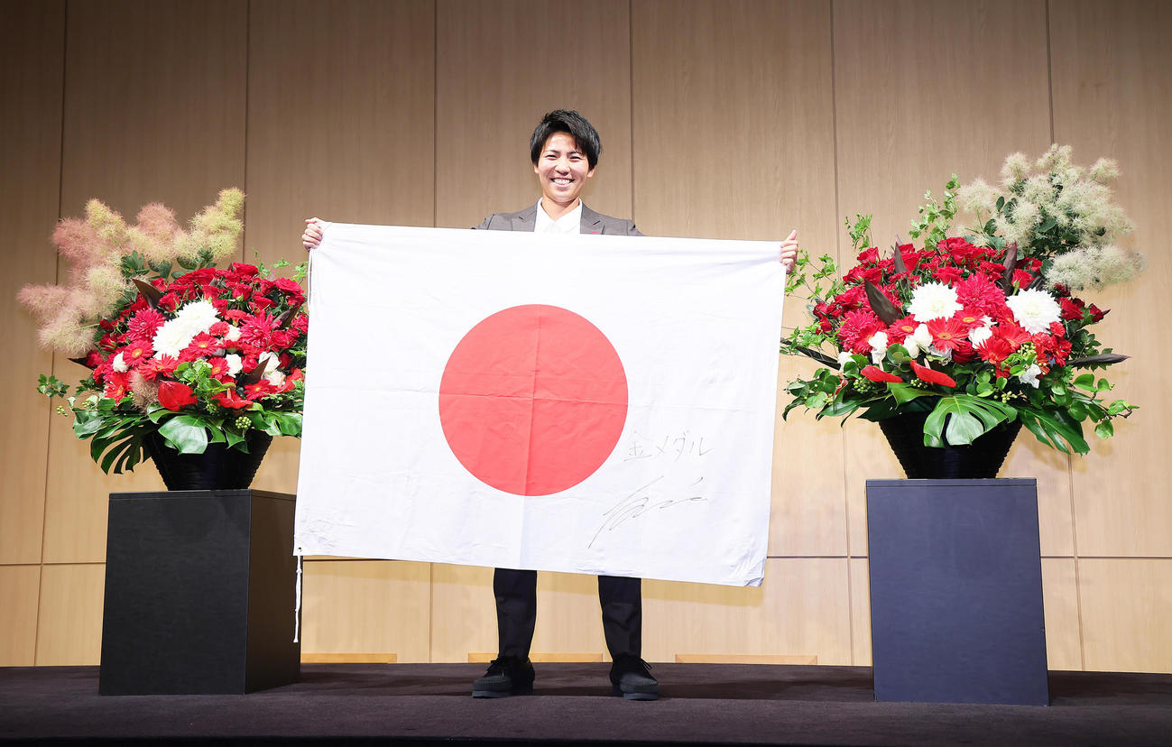 なでしこジャパンパリ五輪メンバーに選出され日の丸を手に笑顔を見せる三菱重工浦和清家（撮影・足立雅史）