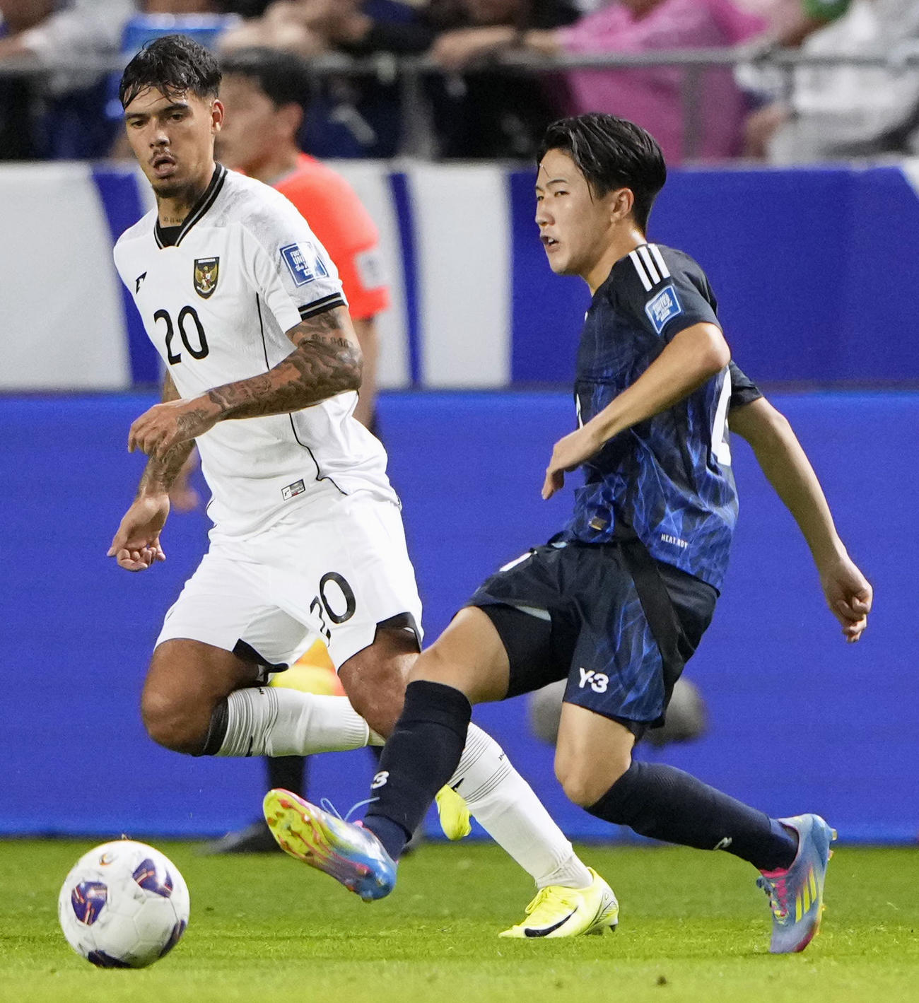 後半、パスを出す佐藤（右）（共同）