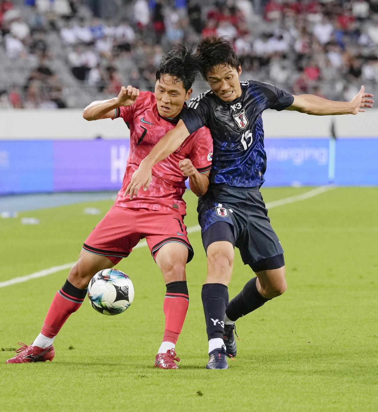 日本―韓国　前半、競り合う韓国の羅相浩（左）と稲垣＝龍仁（共同）