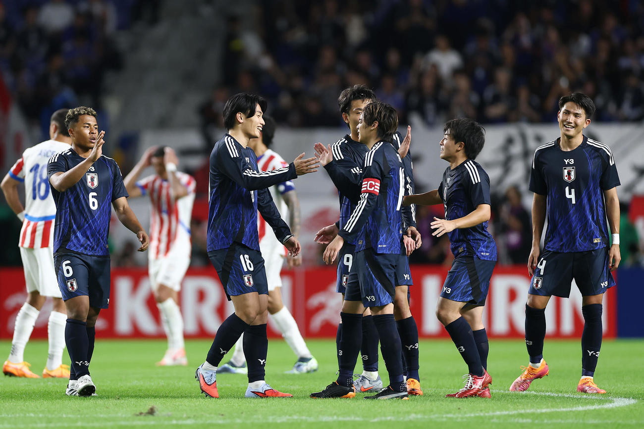 日本対パラグアイ　パラグアイと引き分けに終わり、タッチを交わす上田（左から2人目）ら日本代表の選手たち（撮影・前田充）