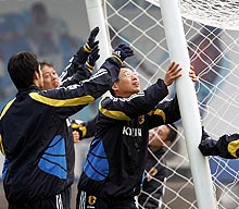 岡田武史監督（中央）はスタッフと一緒にゴールを運ぶ（撮影・蔦林史峰）