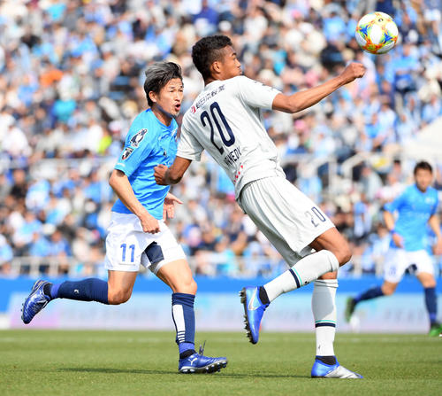 横浜FC対福岡　前半、福岡DF三国ケネディエブス（右）とボールを追う横浜FC・FWカズ（撮影・たえ見朱実）