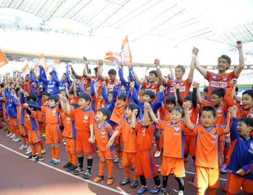 試合後、下部組織の子どもたちとともにバンザイをする新潟のメンバー（撮影・斎藤慎一郎）