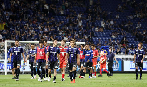 G大阪対長崎　試合後、サポーター（後方）を背に引き揚げるG大阪イレブン（撮影・前田充）