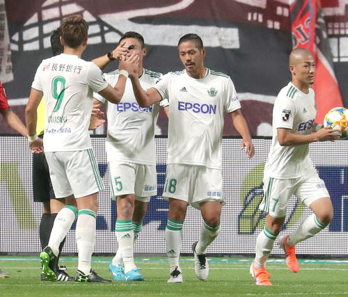 札幌対松本　前半、ゴールを決めチームメートとタッチを交わす松本DF当間（右から2人目）（撮影・佐藤翔太）