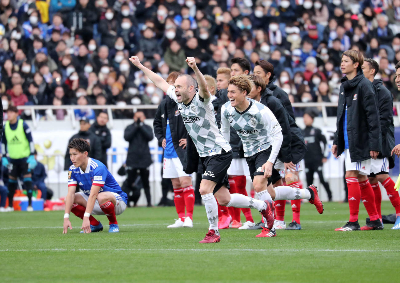 富士ゼロックス・スーパーカップを制しガッツポーズで喜ぶ神戸MFイニエスタ（中央）。後方はガックリする横浜の選手たち（撮影・鈴木正人）