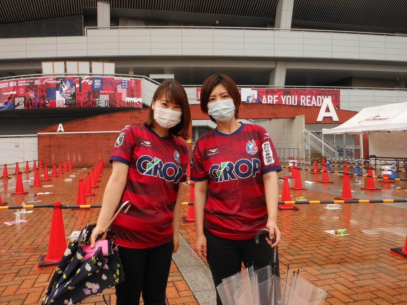 再開後初の有観客試合となるJ2岡山－北九州の試合前、本拠Cスタの前で喜ぶ岡山サポーターの三宅希奈さん（左）と佐藤美鈴さん