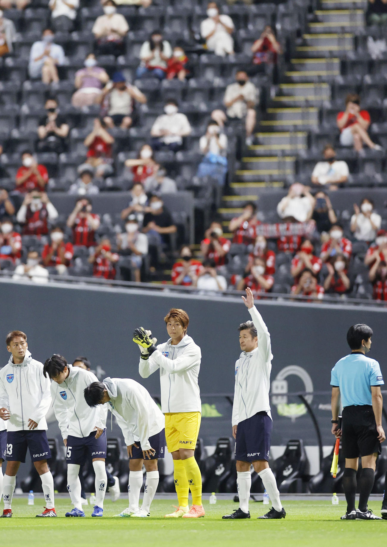 札幌―横浜FC　ピッチへ入場しサポーターの声援に応える横浜FC・三浦（右から2人目）（共同）