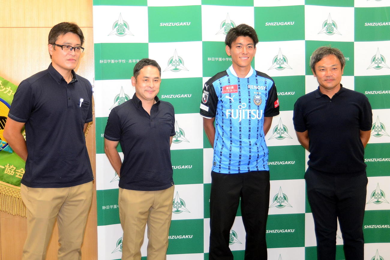 笑顔で写真に収まる、左から川崎Fの竹内強化部長、向島スカウト部長、静岡学園のDF田辺、川口監督