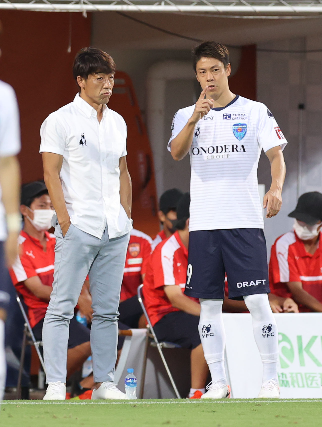 清水対横浜FC　試合前のウオーミングアップで話し合う下平監督（左）と横浜FC・DF伊野波（撮影・狩俣裕三）