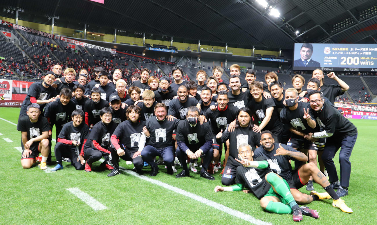 試合後ピッチでペトロビッチ監督（前列左から5人目）のJ1通算200勝を祝う札幌イレブン（クラブ提供）