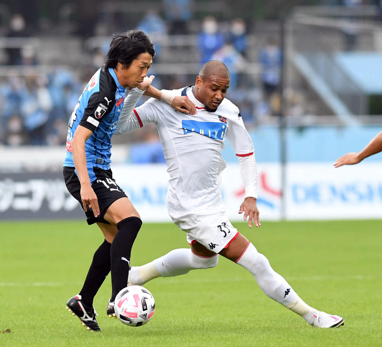 川崎F対札幌　後半、途中出場した川崎F・MF中村（左）は札幌MFドウグラス・オリヴェイラと競り合う（撮影・滝沢徹郎）