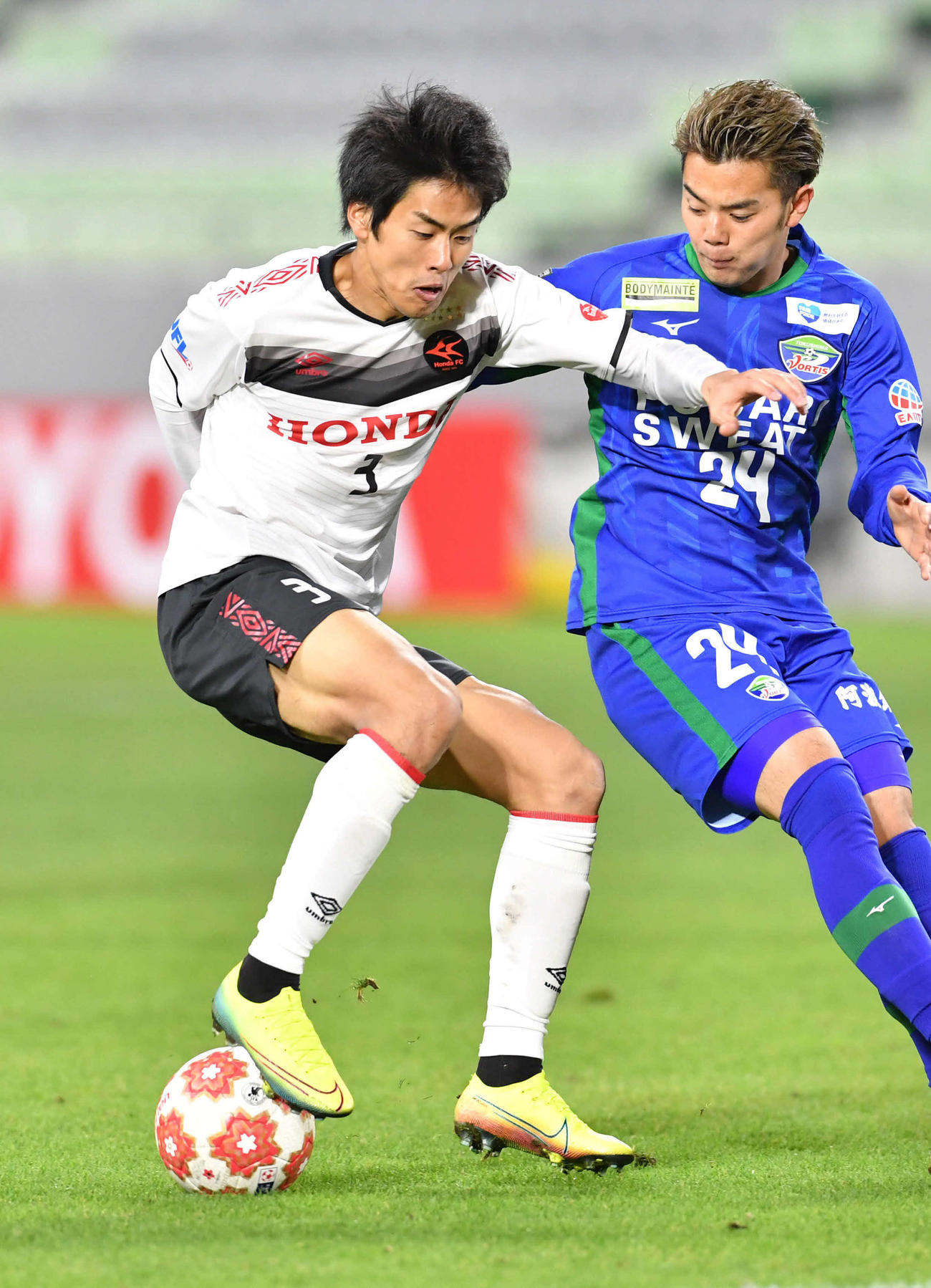 後半、必死にボールをキープするホンダFC・DF三浦（左）（撮影・岩下翔太）