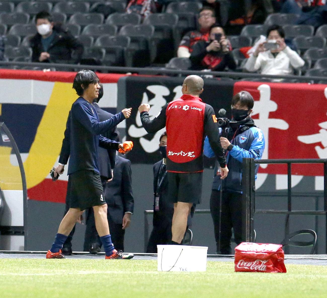 試合前、グータッチを交わす横浜FCのMF中村（左）と札幌MF小野（撮影・佐藤翔太）