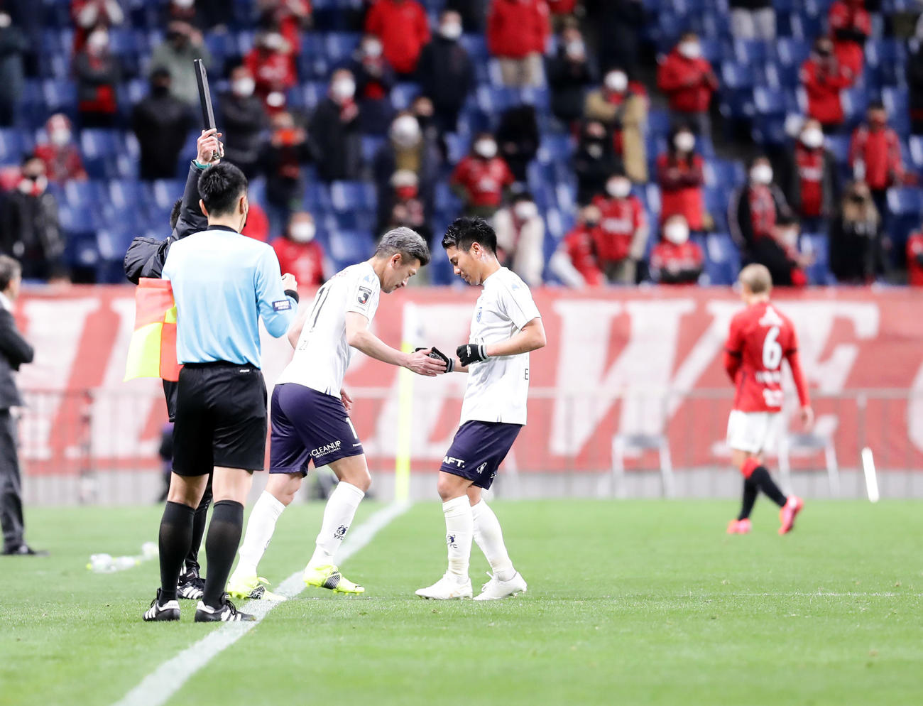 浦和対横浜FC　後半終了間際、横浜FC・FWカズ（中央左）は交代するMF小川とタッチしてピッチに入る（2021年3月10日撮影）