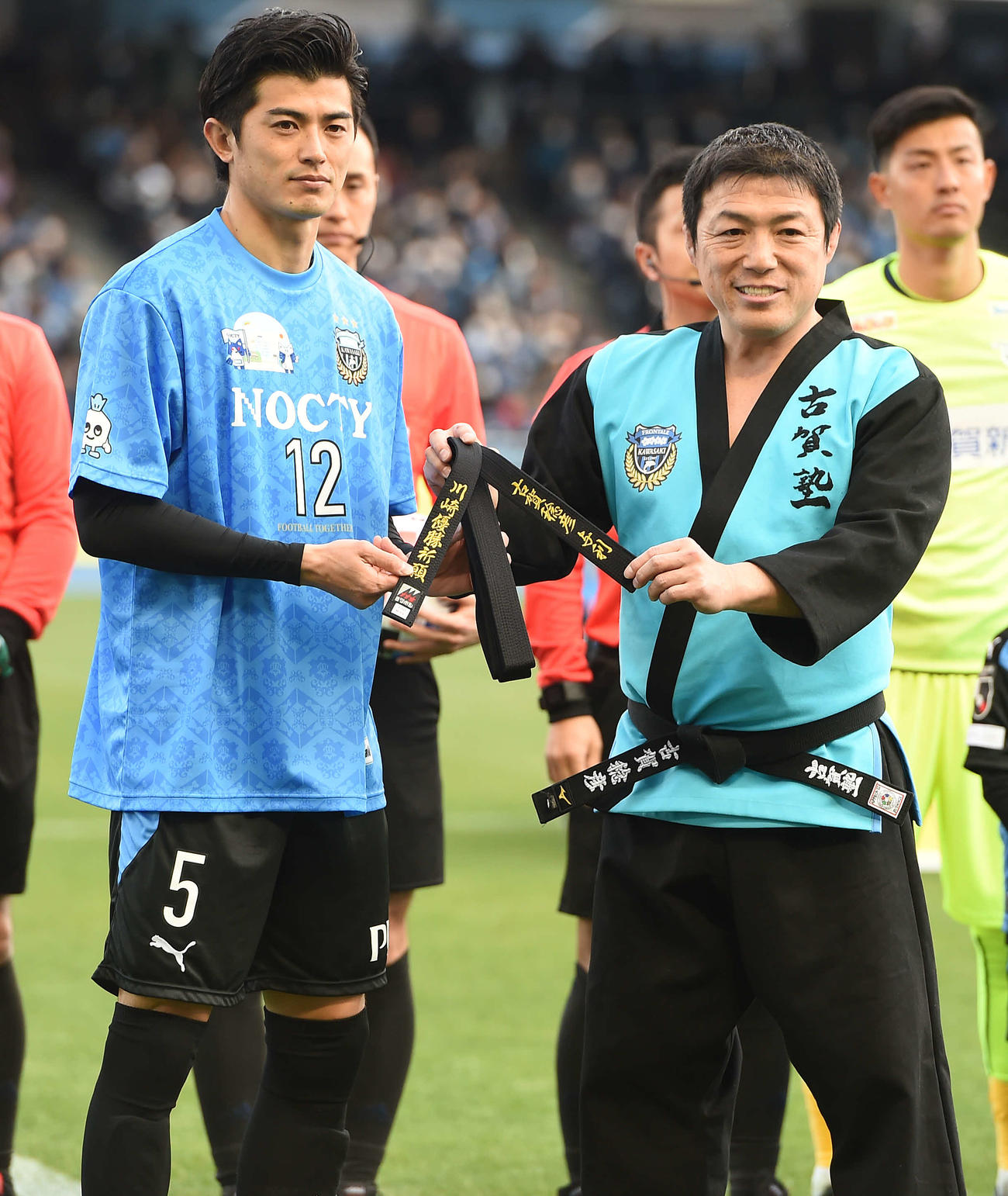 20年2月22日、川崎F対鳥栖　川崎F・DF谷口彰悟（左）に黒帯を渡す古賀稔彦氏