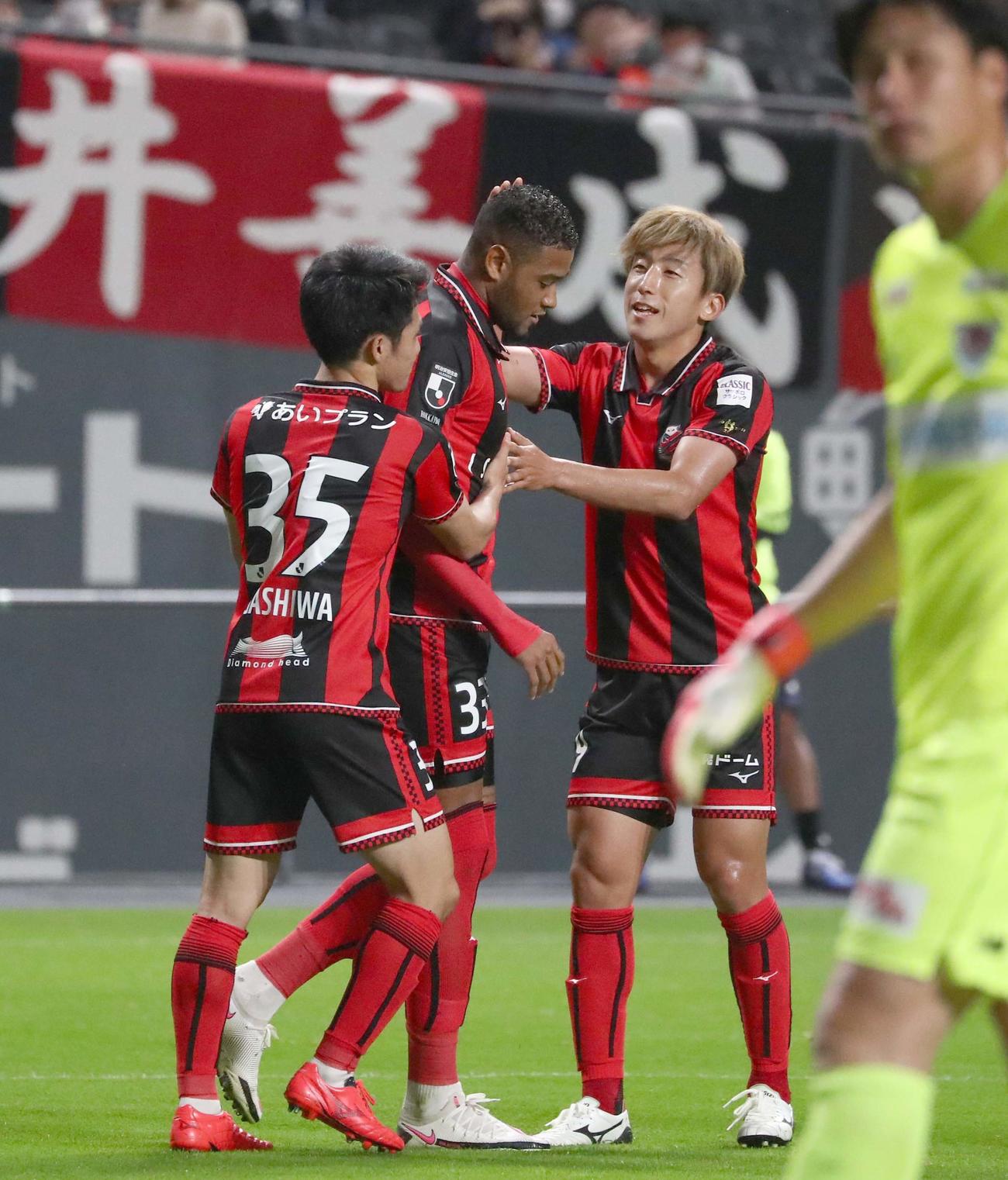 札幌対鳥栖　前半26分、PKがGKに阻まれるも跳ね返ったボールを押し込み先制点を決め祝福されるFWドウグラス（中央）（撮影・黒川智章）