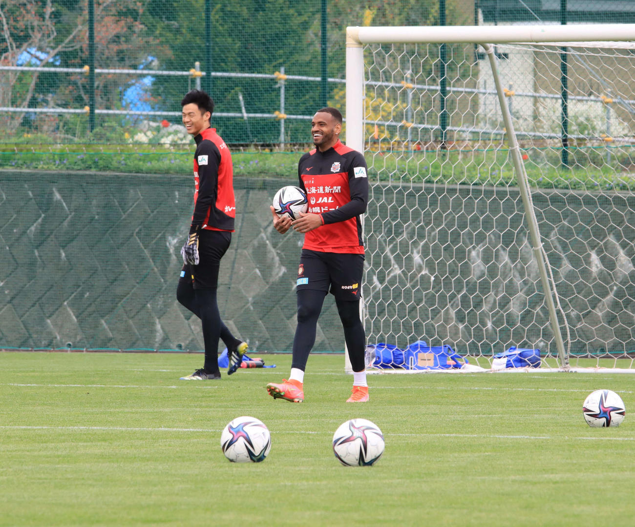 札幌FWアンデルソン・ロペス（右）は練習中に笑顔を見せる。左はGK中野（撮影・保坂果那）