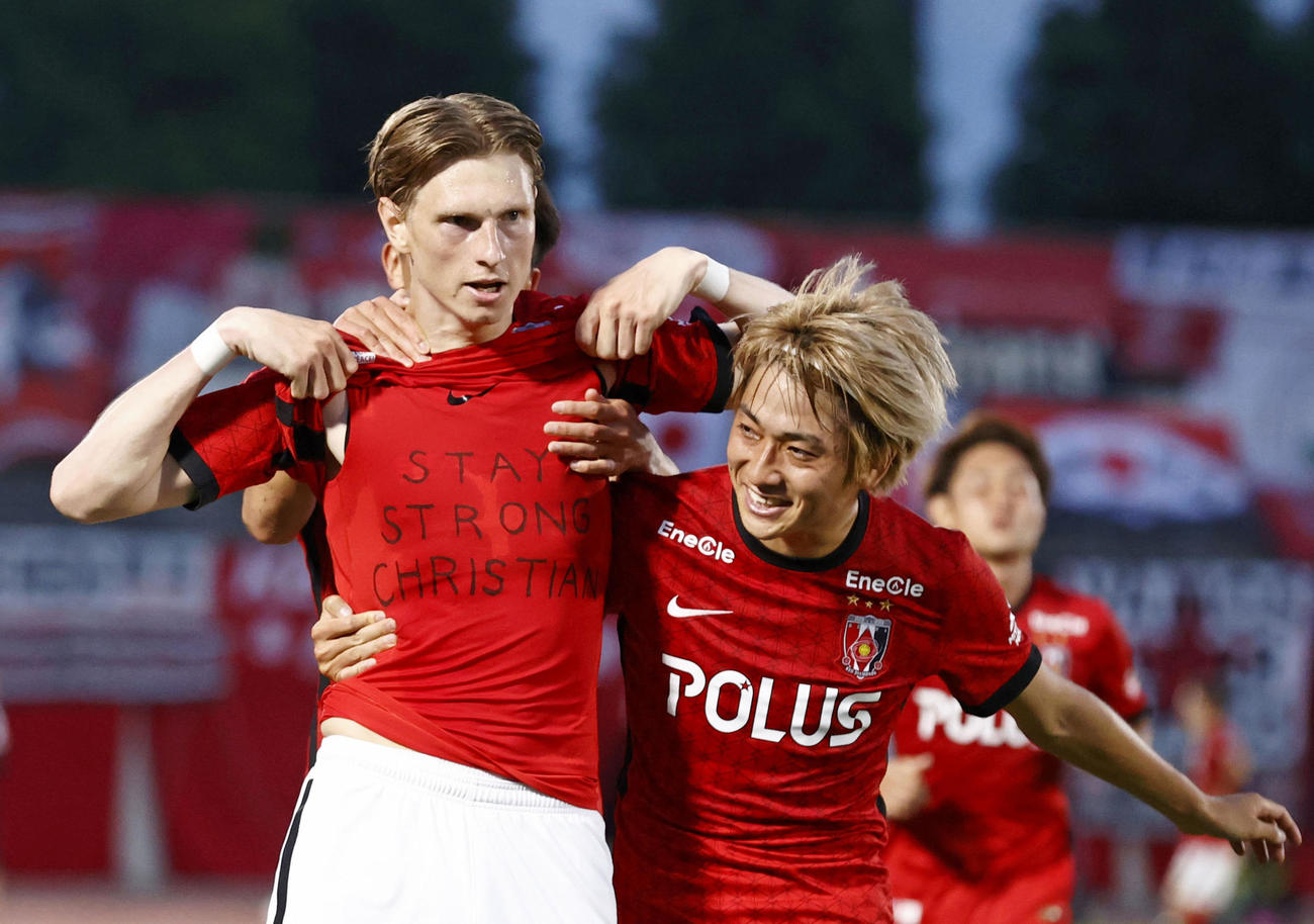浦和―神戸　前半終了間際、ゴールを決め、欧州選手権の試合中に倒れたデンマークのエリクセンへエールを送る浦和・ユンカー。右は小泉