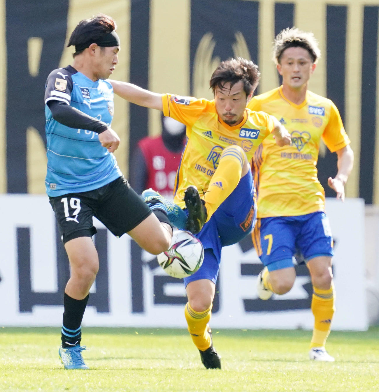 仙台対川崎F　前半、川崎F・FW遠野（左）と競り合う仙台MF富田。右は同MF関口（2021年3月6日撮影）