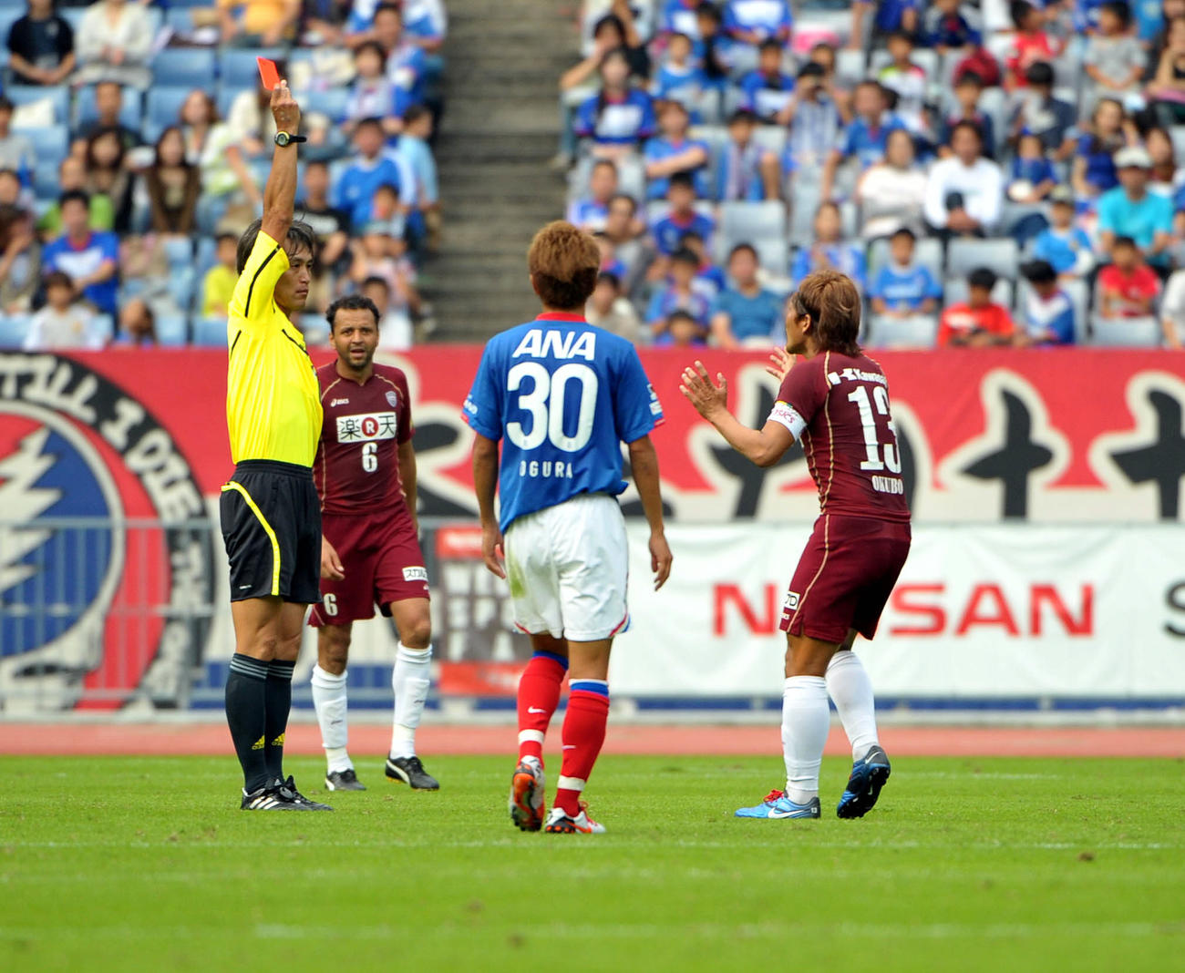 2010年10月、村上伸次主審（左端）からレッドカードを出され（退場になり）抗議する神戸FW大久保嘉人