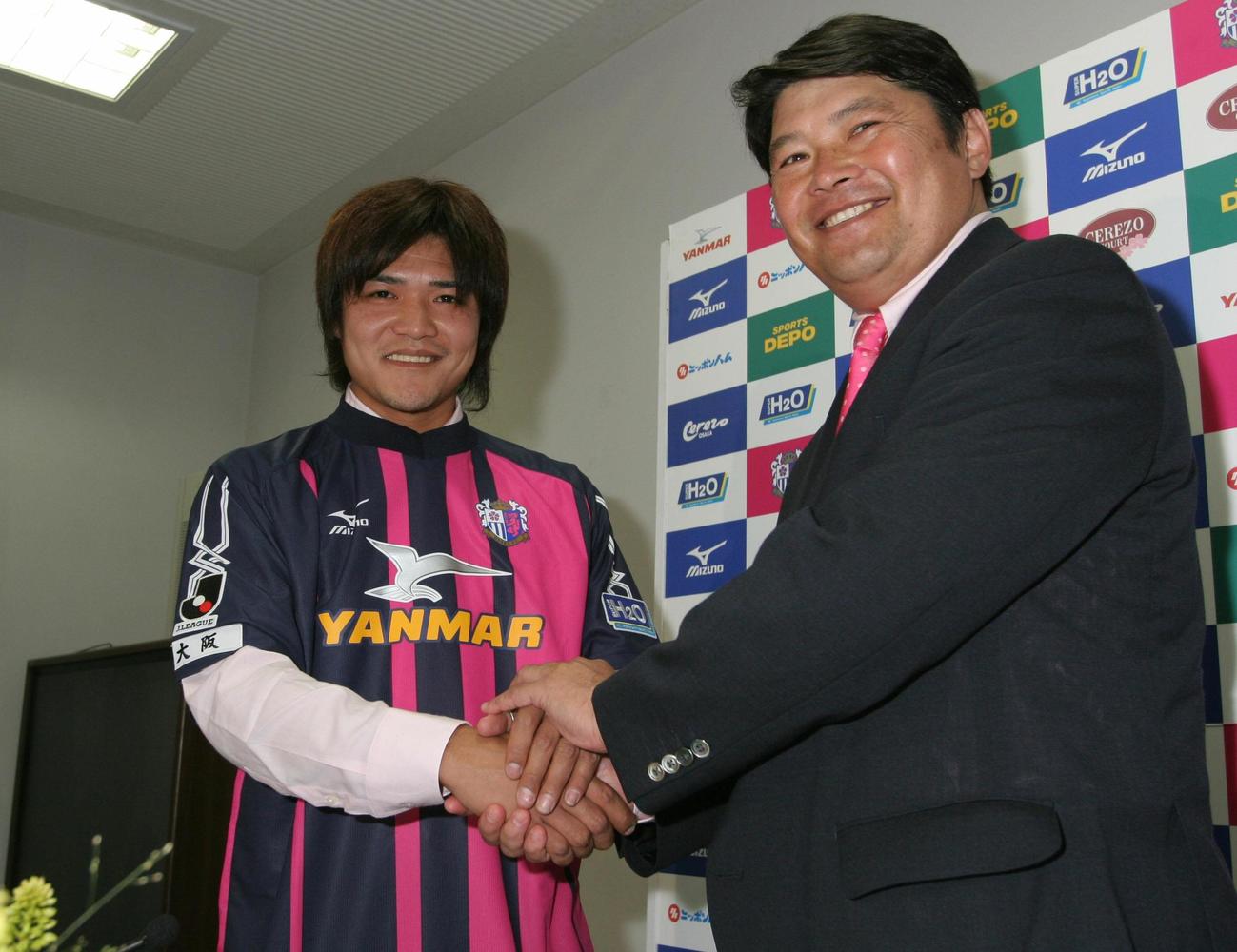 2006年6月、大久保嘉人（左）は西村昭宏GMと握手を交わし笑顔で入団発表