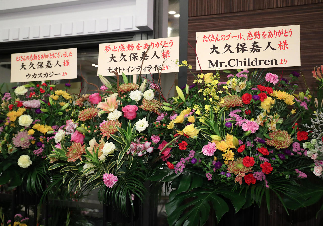 C大阪大久保の引退会見に届いた花のスタンド。左からウカスカジー、ナオト・インティライミ、Mr．Children（撮影・白石智彦）