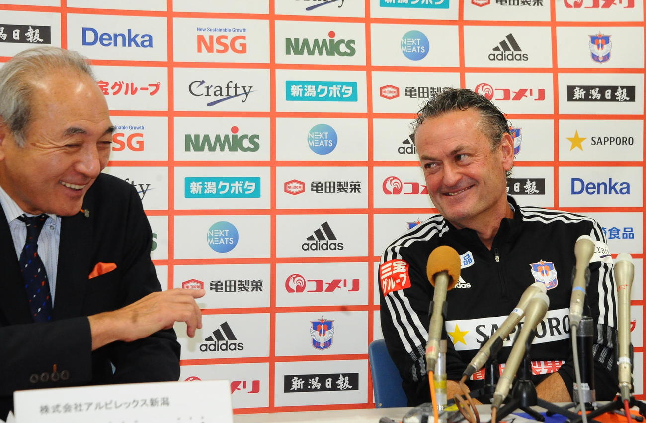 中野社長（左）を笑顔で見つめるアルベルト監督