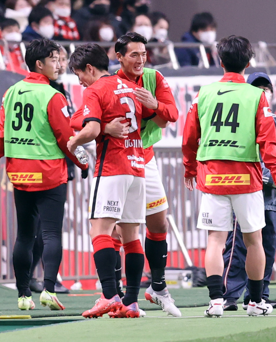 浦和対C大阪　後半、交代でピッチを出た浦和宇賀神（手前）は槙野から抱擁で迎えられる（撮影・浅見桂子）