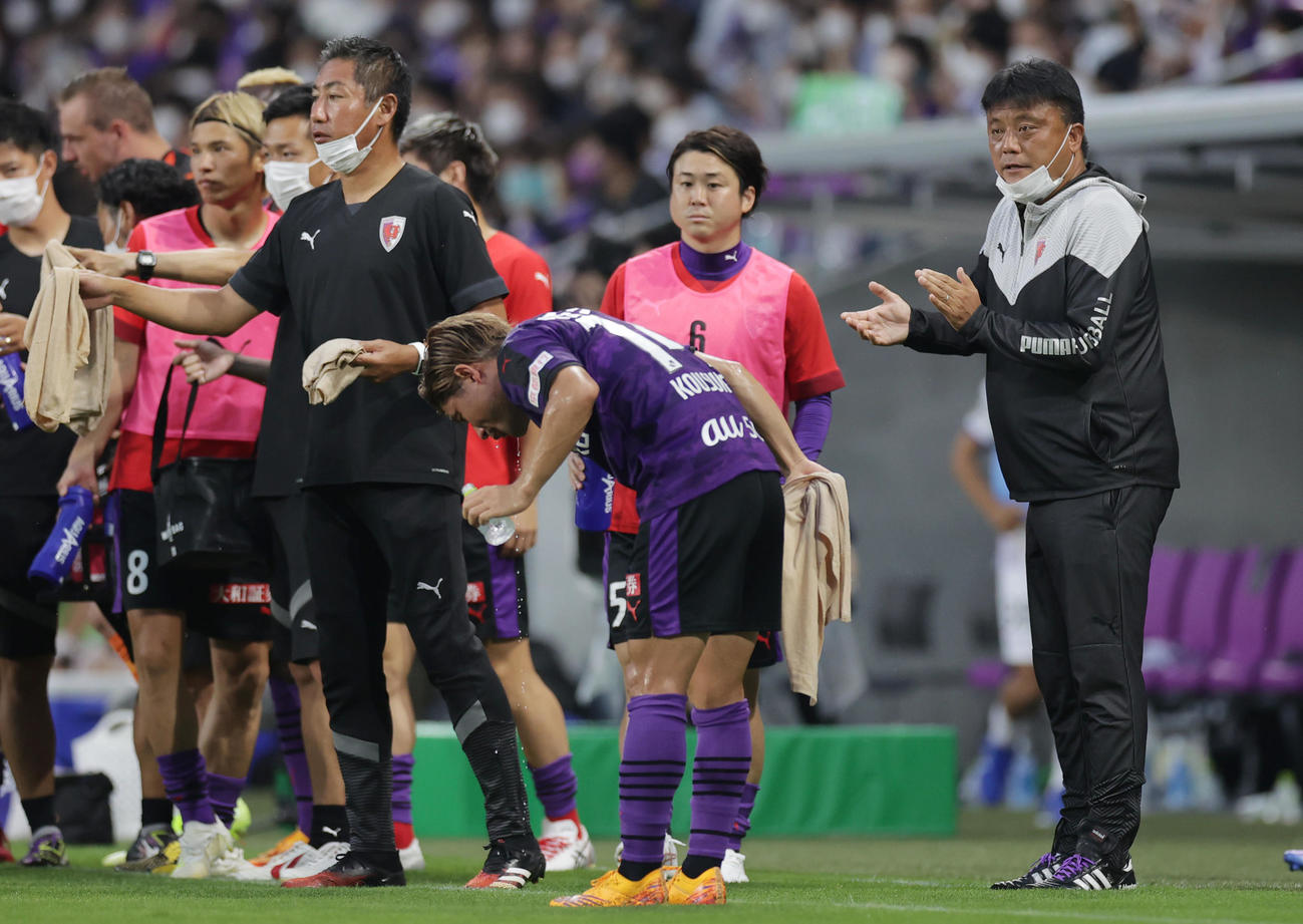 京都対広島　前半、飲水タイムで選手を拍手で迎える京都曹監督（右端）（撮影・前田充）