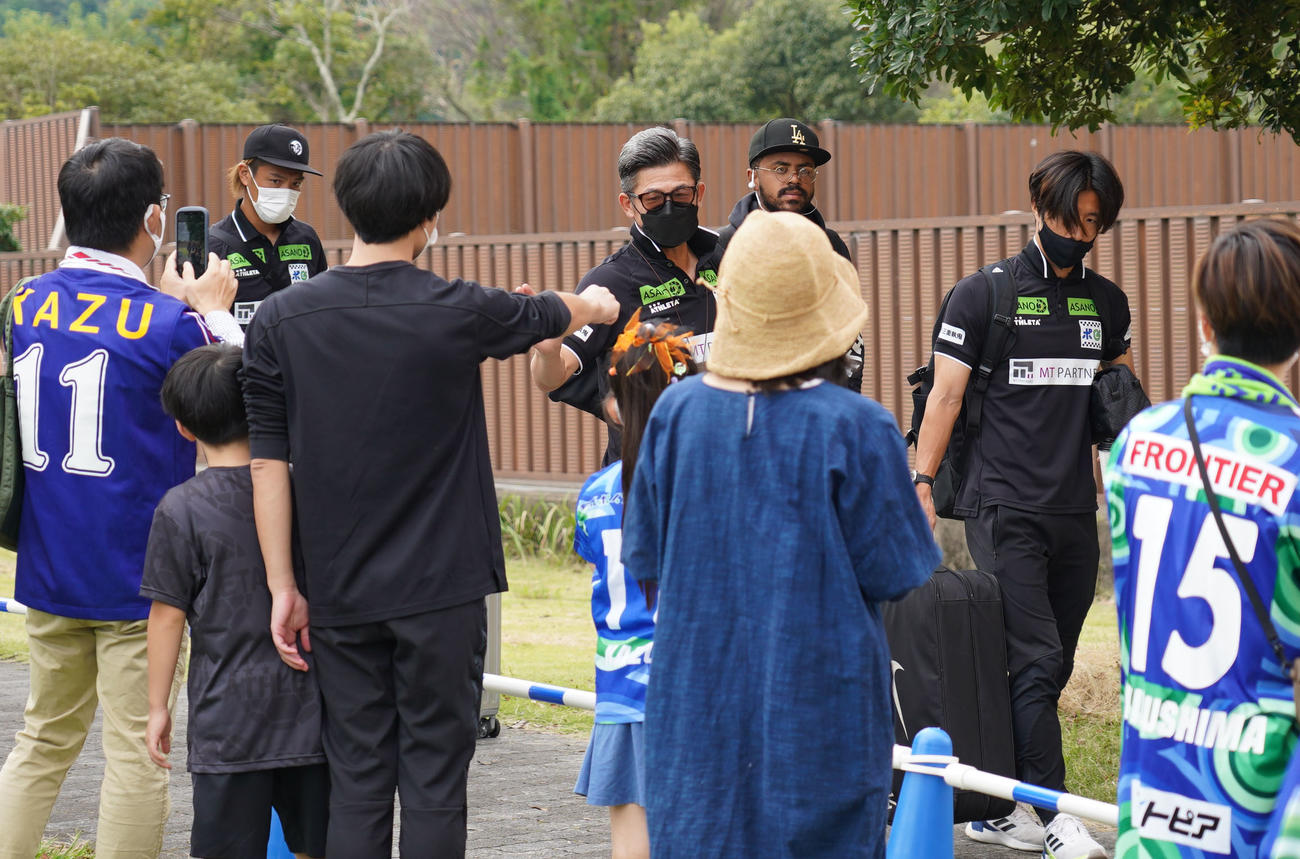 鈴鹿対滋賀　試合会場に到着し子どもたちに手を振る三浦知（中央）（撮影・森本幸一）