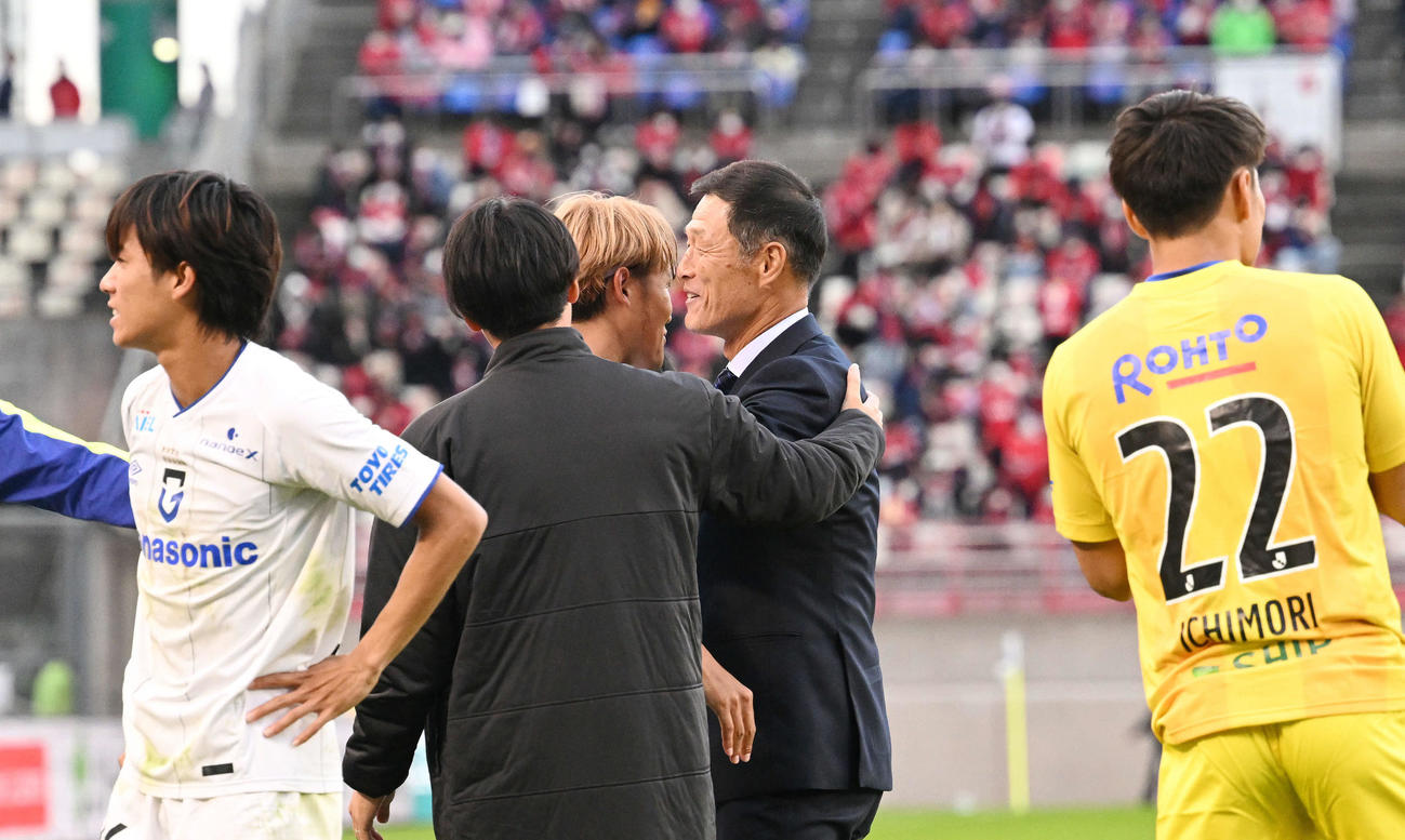 鹿島対G大阪　試合後、1部残留が決まりG大阪松田監督（中央右）は宇佐美と抱き合って喜ぶ（撮影・滝沢徹郎）