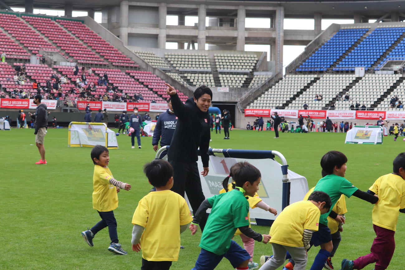 JFAユニクロサッカーキッズのイベントで子供たちとサッカーを楽しむ内田篤人氏（中央）