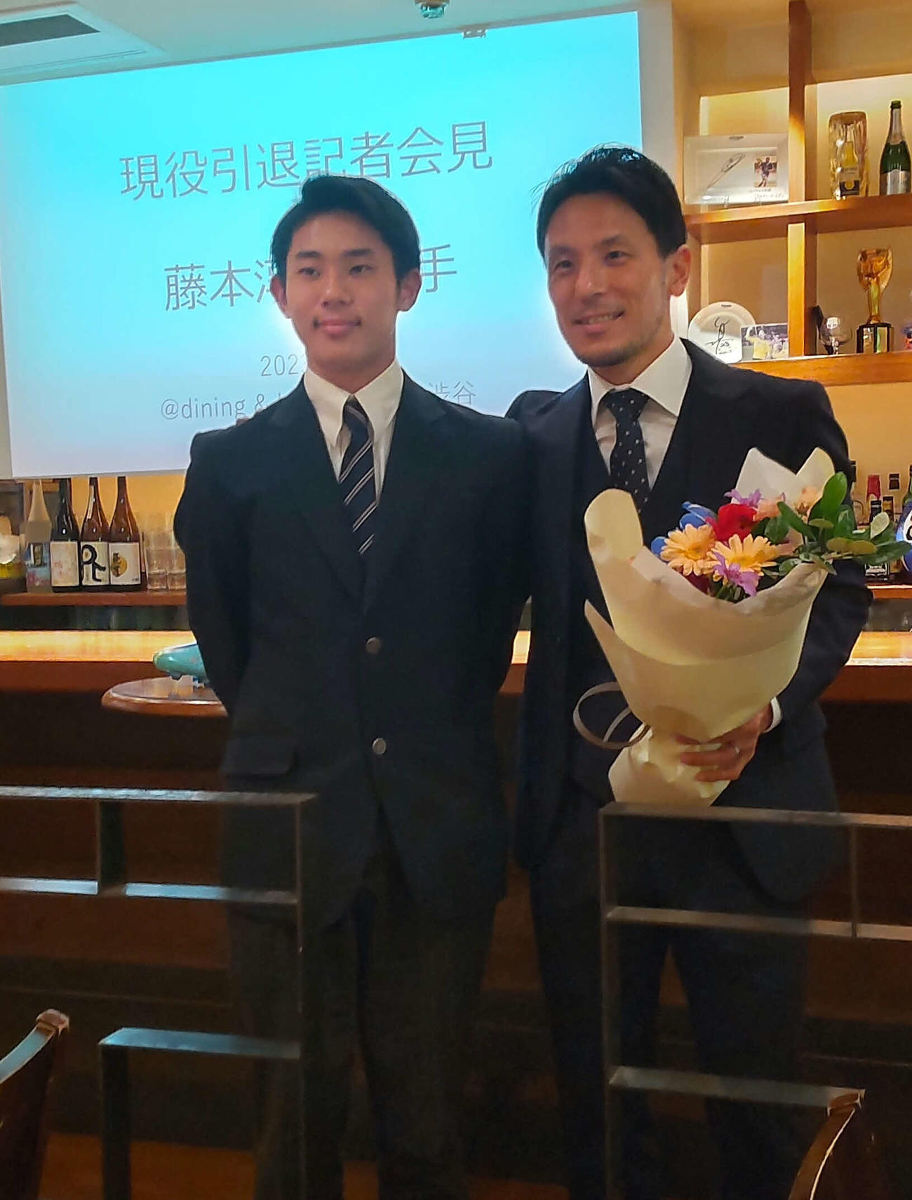 引退会見した元日本代表MF藤本淳吾（右）は、中学3年の長男歩優（あるま）さんから花束を贈られる