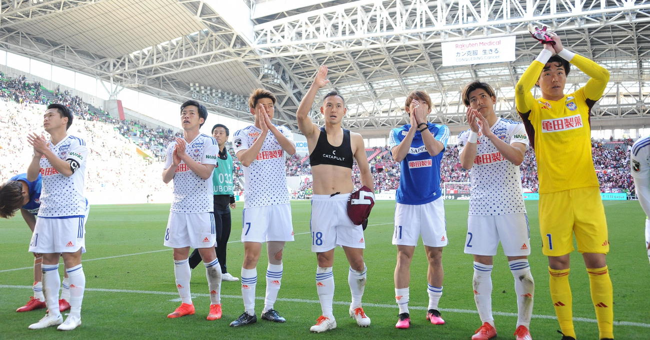 試合後、サポーターにあいさつをする新潟の選手たち。右は好セーブ連発の小島