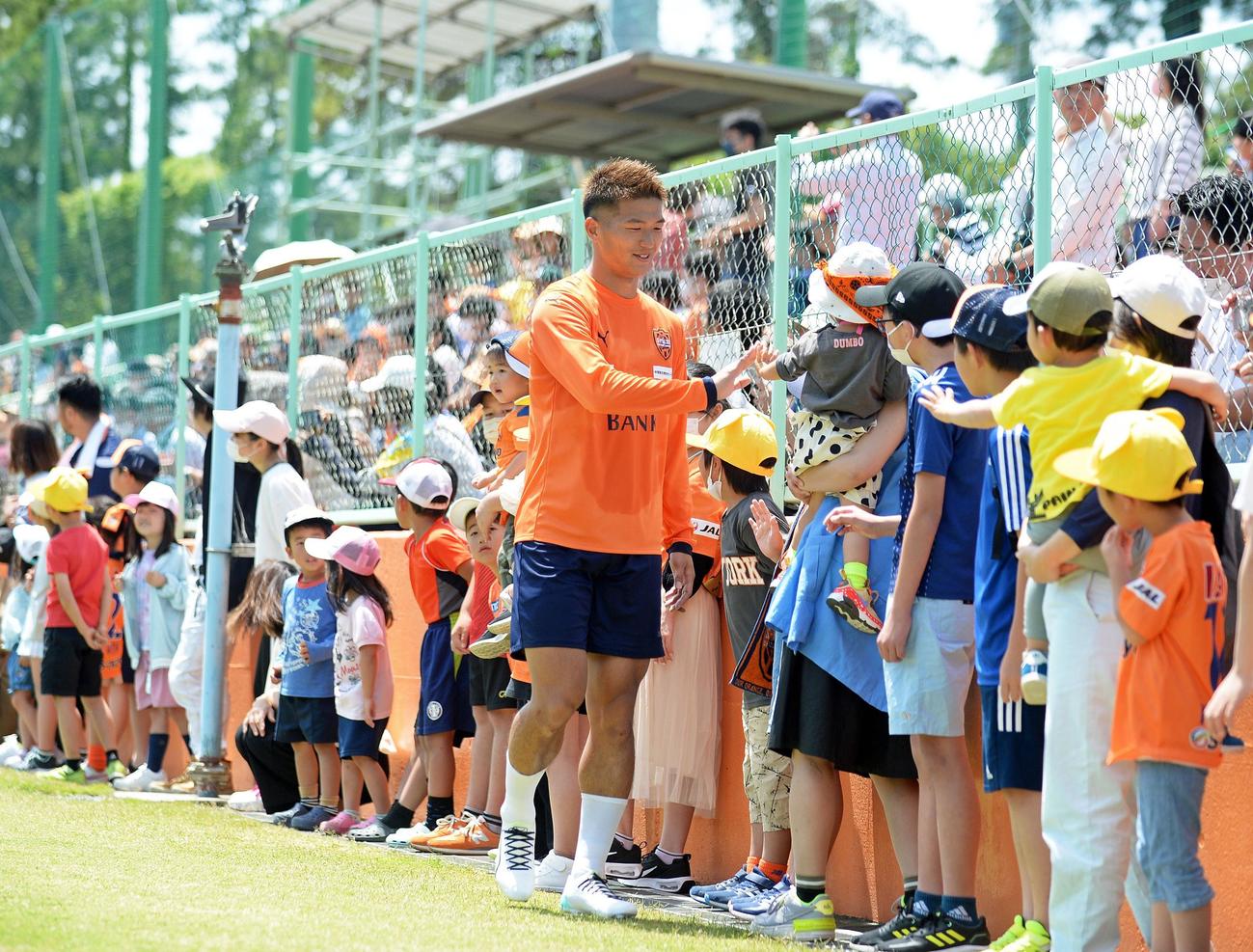子どもたちとハイタッチする清水北川