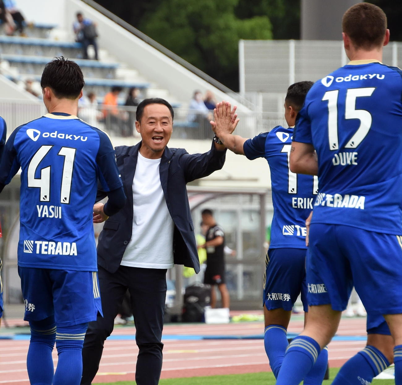 後半、町田FWデューク（右）がチーム3点目を決めて笑顔の黒田監督（左から2人目）