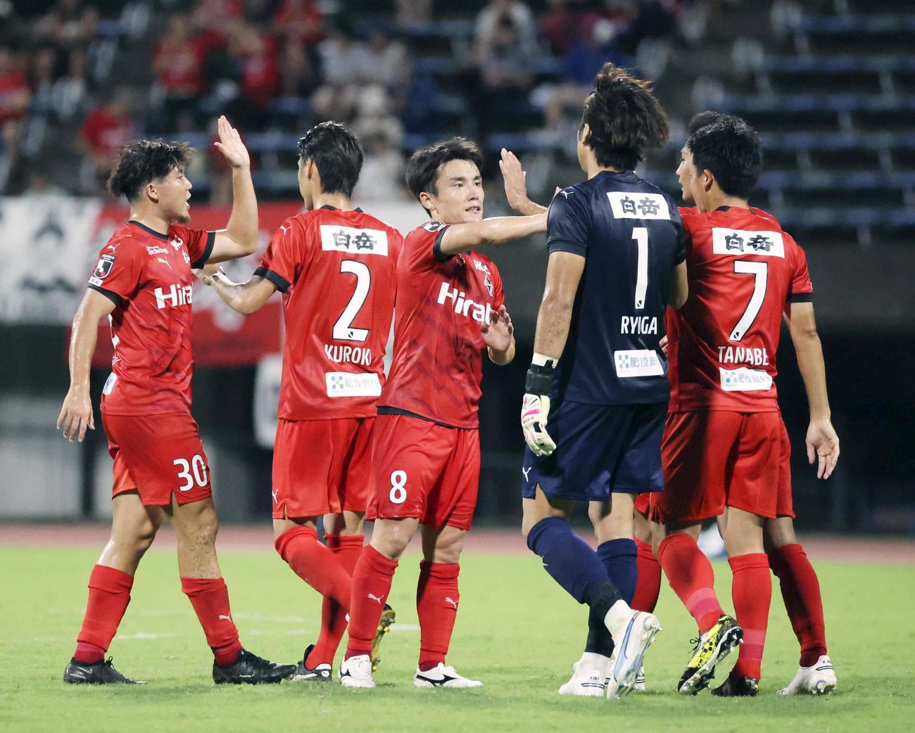 FC東京に勝利し、タッチを交わす熊本イレブン（共同）