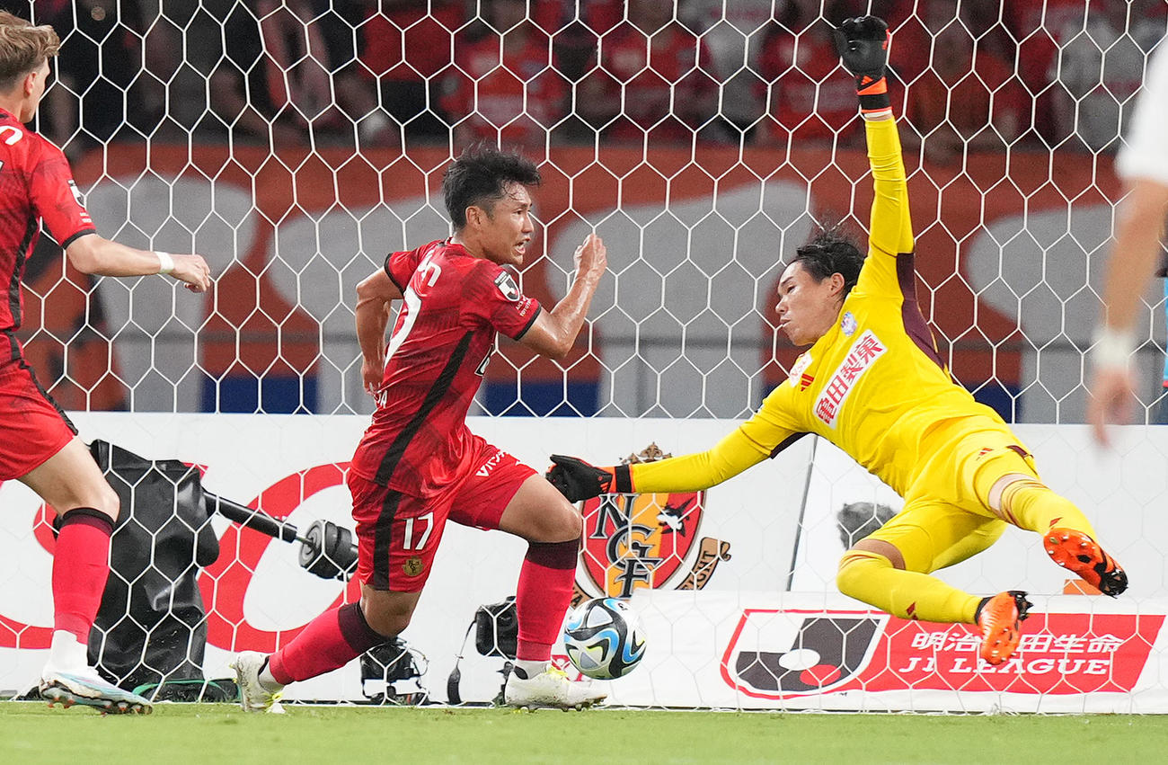 名古屋対新潟　前半、先制のゴールを決める名古屋森下（左）。右はGK小島（撮影・菅敏）