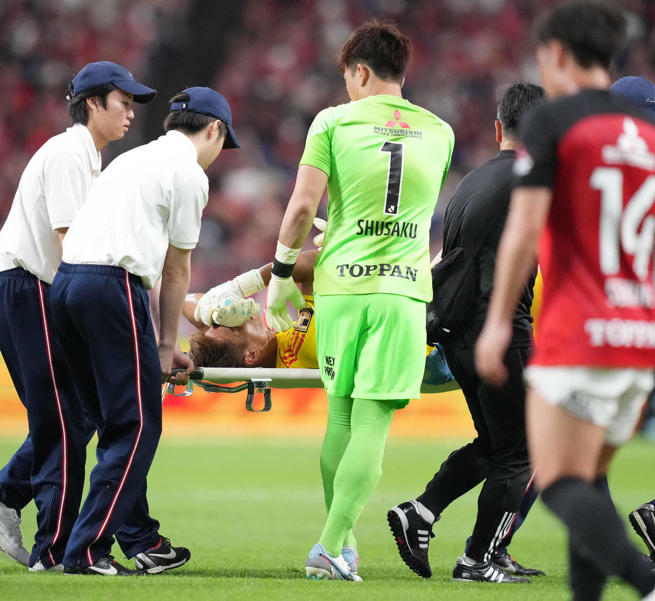 浦和対横浜　後半、負傷し担架に乗せられ交代となる横浜GK一森純に声をかける浦和GK西川周作