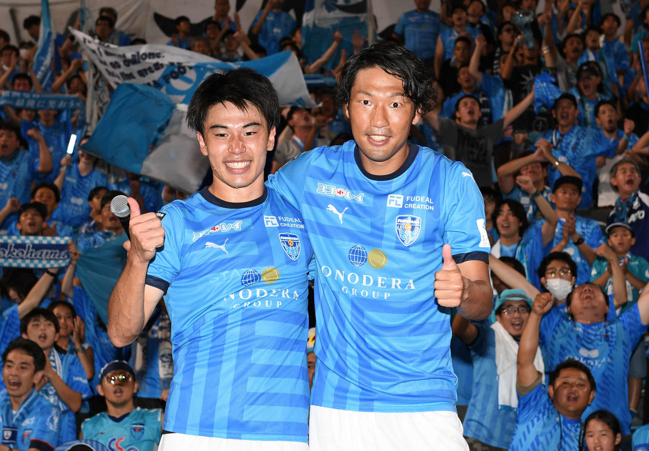 横浜FC対横浜　横浜FC伊藤（右）と林は勝利を喜ぶサポーターと記念撮影（撮影・山崎安昭）
