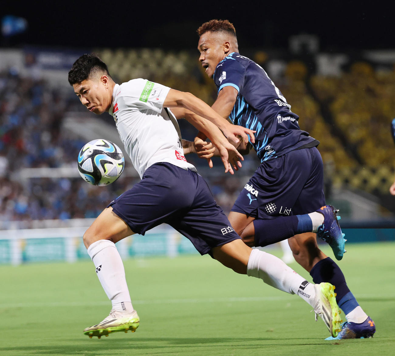横浜FC対柏　前半、横浜FCンドカ・ボニフェイス（右）をかわし突破を図る柏細谷（撮影・野上伸悟）