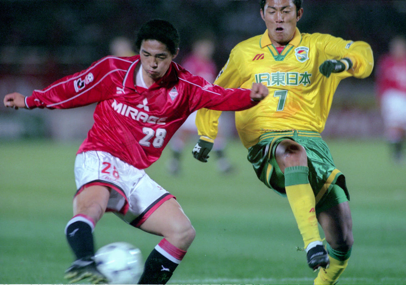 98年3月21日、Jリーグデビュー戦　市原・金晃正(右)のマークをかわしセンターリングを上げる浦和小野伸二