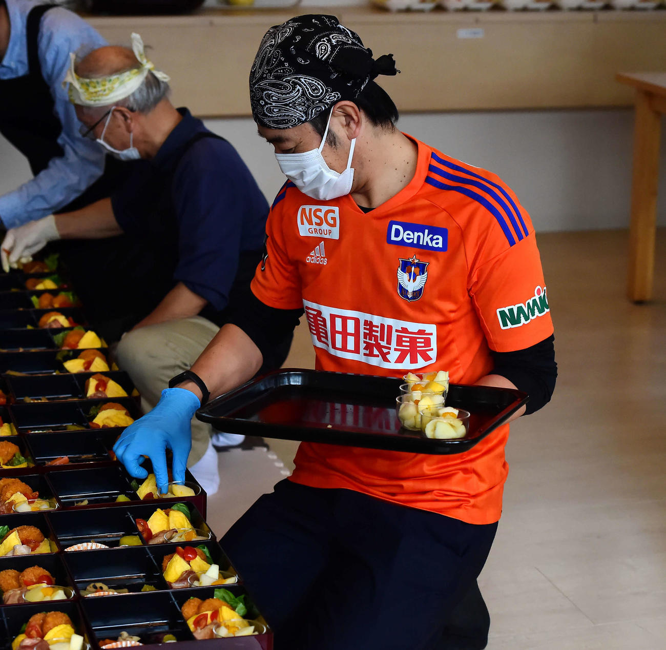 料理の盛り付けをする野沢営業本部長
