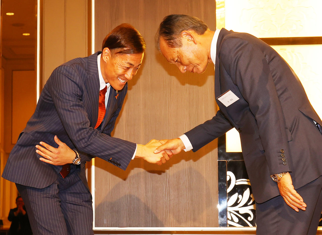 引退会見後の囲む会で、大宮原本部長（右）と握手する大宮GK南（撮影・野上伸悟）