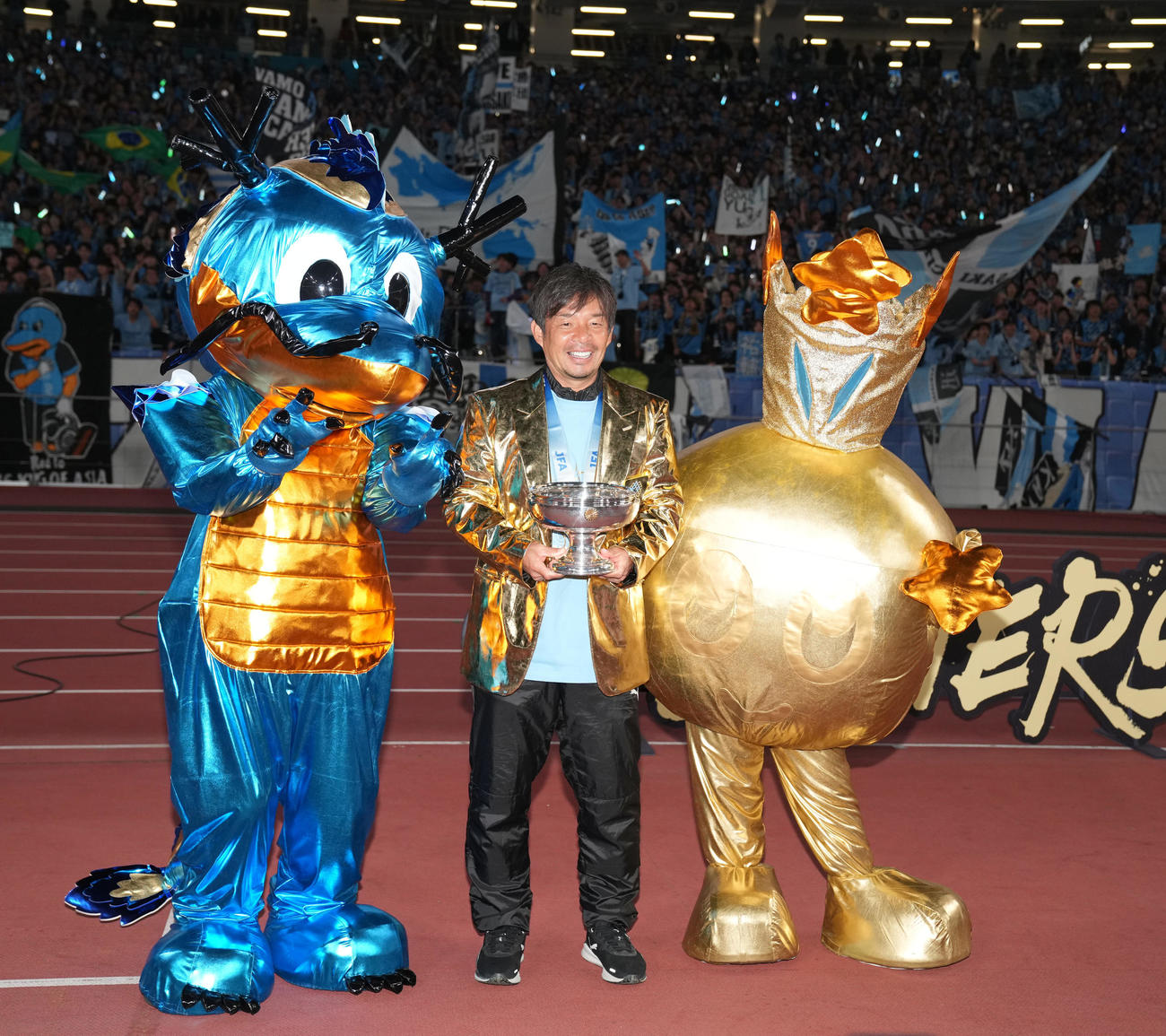 川崎F対柏　金色のジャケットを着て天皇杯をてにする川崎F鬼木監督（中央）（撮影・井上学）