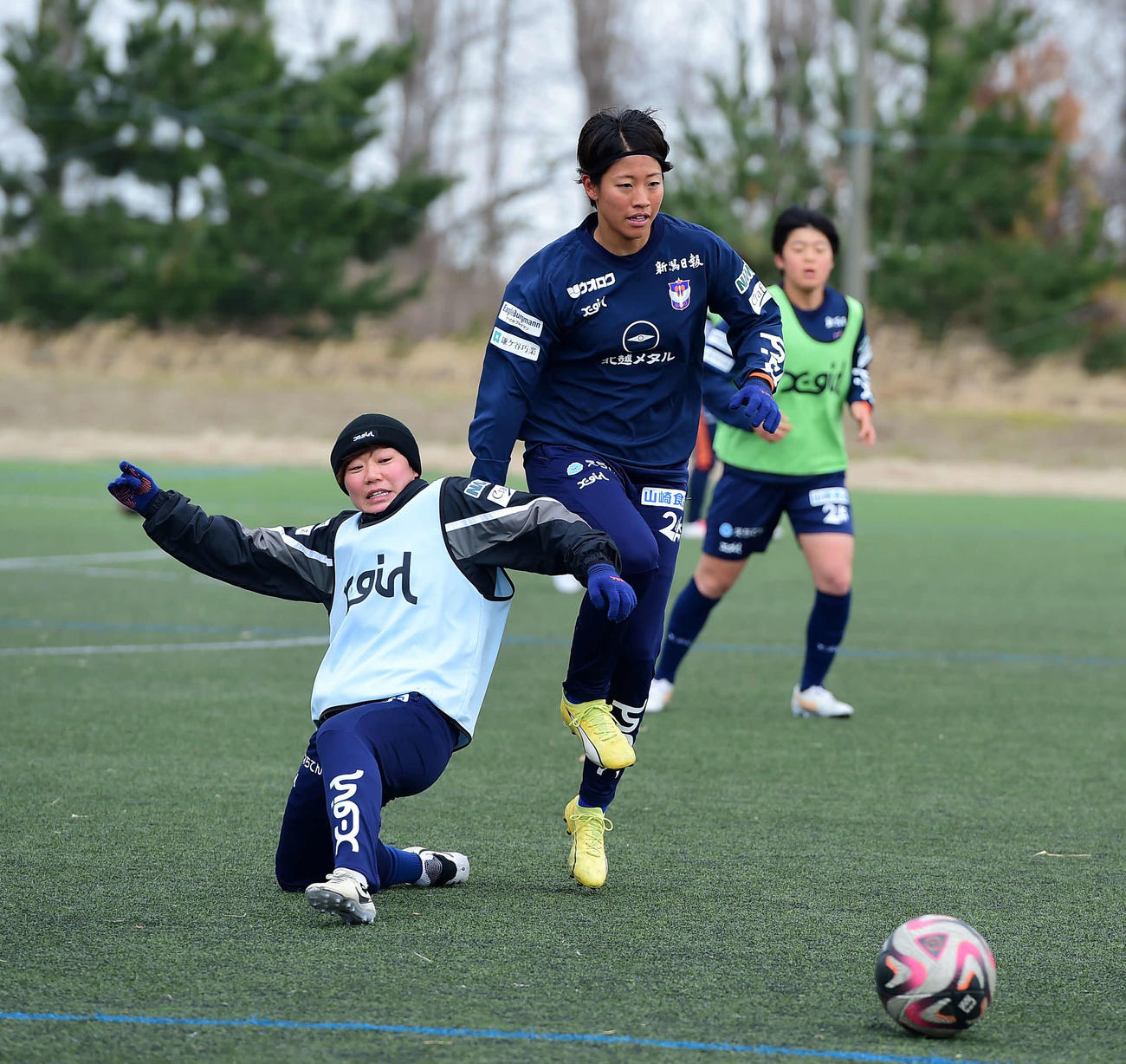 競り合う新潟レディース石淵（右）